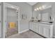 Bathroom featuring a double vanity, tile floors and a door to the walk-in closet at 7834 Minutemen Loop, Winter Garden, FL 34787
