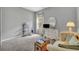 Comfortable bedroom boasts a cozy sitting area and a large window for plenty of natural light at 7834 Minutemen Loop, Winter Garden, FL 34787