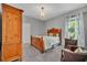 Cozy bedroom with wood furnishings, a chandelier, and a window providing natural light at 7834 Minutemen Loop, Winter Garden, FL 34787