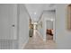 Bright and spacious hallway featuring tile flooring, recessed lighting, and access to various rooms at 7834 Minutemen Loop, Winter Garden, FL 34787