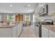 Well-equipped kitchen with stainless steel appliances, granite countertops and adjacent dining area at 7834 Minutemen Loop, Winter Garden, FL 34787