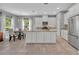Modern kitchen and dining area with stainless steel appliances, ample counter space and natural lighting at 7834 Minutemen Loop, Winter Garden, FL 34787