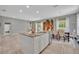 Spacious kitchen with an island, stainless steel appliances and an eat-in dining area at 7834 Minutemen Loop, Winter Garden, FL 34787