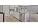 Open kitchen featuring stainless steel appliances, granite countertops and view to an adjacent living area at 7834 Minutemen Loop, Winter Garden, FL 34787