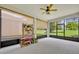 The covered lanai offers an extended living space with views of the lush green yard at 7834 Minutemen Loop, Winter Garden, FL 34787