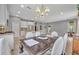 Open concept kitchen and dining area with an island, dining table, and view into living area at 7834 Minutemen Loop, Winter Garden, FL 34787