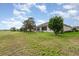 Beautiful home featuring an expansive lawn with mature trees and view of the neighborhood at 8865 Se 119Th St, Summerfield, FL 34491