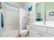 Clean bathroom with a tub, shower, white vanity, and decorative accents at 8865 Se 119Th St, Summerfield, FL 34491