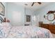 Bedroom with bed and bedding, ceiling fan, and a dresser with decorative items at 8865 Se 119Th St, Summerfield, FL 34491