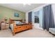 Cozy bedroom featuring a wooden bed frame, soothing wall color, and a bright window at 8865 Se 119Th St, Summerfield, FL 34491