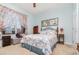 Cozy bedroom featuring a bed with patterned bedding, side tables, and natural light at 8865 Se 119Th St, Summerfield, FL 34491
