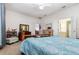 Inviting bedroom with a wooden bed frame, soft lighting, and ensuite bathroom with vanity at 8865 Se 119Th St, Summerfield, FL 34491