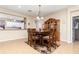 Dining area featuring tile floors, a wooden table with seating for six, and a view into the kitchen at 8865 Se 119Th St, Summerfield, FL 34491