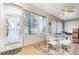 Bright Florida room with windows, a dining table, and access to the backyard at 8865 Se 119Th St, Summerfield, FL 34491