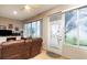 Enclosed sunroom featuring large windows, tile floors, casual seating, and access to the outdoors at 8865 Se 119Th St, Summerfield, FL 34491