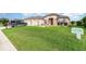 Charming single-story home with beautiful lawn, manicured landscaping, and neutral-toned stucco exterior at 8865 Se 119Th St, Summerfield, FL 34491