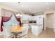 Bright eat-in kitchen with white cabinets, island, stainless appliances, and a charming breakfast nook with natural light at 8865 Se 119Th St, Summerfield, FL 34491