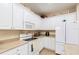 Bright kitchen featuring white cabinets, appliances, and countertops, with whimsical birdhouse decor at 8865 Se 119Th St, Summerfield, FL 34491