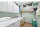 Functional laundry room with washer, dryer, storage cabinets and shelving at 8865 Se 119Th St, Summerfield, FL 34491