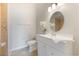 Clean bathroom with a white vanity and a shower with decorative tile at 9494 Lake Lotta Cir, Gotha, FL 34734