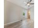 Bedroom with hard wood flooring, ceiling fan, and attached bath at 9494 Lake Lotta Cir, Gotha, FL 34734