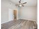 Large bedroom featuring hard wood floors, ceiling fan, and walk in closet at 9494 Lake Lotta Cir, Gotha, FL 34734