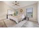 Bright bedroom with wood floors, ceiling fan, and a stylish area rug at 9494 Lake Lotta Cir, Gotha, FL 34734