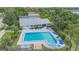 Aerial view showcasing a pristine community pool with ample lounge seating, perfect for relaxation and socializing at 9494 Lake Lotta Cir, Gotha, FL 34734