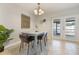 Bright dining area with a modern table set, chandelier, and access to the outdoor patio at 9494 Lake Lotta Cir, Gotha, FL 34734