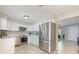 Well-lit kitchen featuring stainless steel appliances, white cabinetry, and seamless access to the living area at 9494 Lake Lotta Cir, Gotha, FL 34734