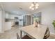 Open-concept kitchen and dining area featuring modern appliances, white cabinets, and tile flooring at 9494 Lake Lotta Cir, Gotha, FL 34734