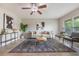 Open living area with tile floors, modern furnishings, and a ceiling fan for comfortable living at 9494 Lake Lotta Cir, Gotha, FL 34734