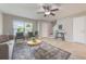 Cozy living room boasts tile floors, a ceiling fan, and neutral decor, creating a welcoming space at 9494 Lake Lotta Cir, Gotha, FL 34734