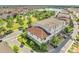 Aerial view showcases the townhome's location near a scenic lake, pool, and well-maintained green spaces at 9533 Mere Pkwy, Orlando, FL 32832