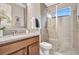 Updated bathroom featuring a granite countertop, single sink, and a glass-enclosed shower for a spa-like experience at 9533 Mere Pkwy, Orlando, FL 32832