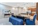 Dining space with a long table, blue upholstered bench and chairs, adjacent to the kitchen at 9533 Mere Pkwy, Orlando, FL 32832