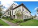Beautiful multi-story condo building with manicured landscaping, sidewalks, and a welcoming entrance at 9533 Mere Pkwy, Orlando, FL 32832