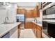 Kitchen with stainless steel appliances, light countertops, and wooden cabinets at 9533 Mere Pkwy, Orlando, FL 32832