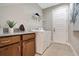 Well-equipped laundry room with ample counter space, modern washer and dryer, and convenient storage solutions at 9533 Mere Pkwy, Orlando, FL 32832