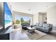 Cozy living room featuring gray sofas, a large window with a view, and a modern entertainment center at 9533 Mere Pkwy, Orlando, FL 32832