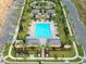 A bird's eye view highlights the community pool, featuring lounge chairs, covered seating areas, and manicured landscaping at 9533 Mere Pkwy, Orlando, FL 32832