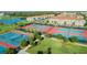 Overhead view of multiple red and blue tennis courts, and basketball court, nestled in a green lawn at 9533 Mere Pkwy, Orlando, FL 32832