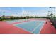 Multiple outdoor tennis courts with well maintained surfaces and surrounding landscaping at 9533 Mere Pkwy, Orlando, FL 32832