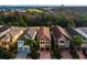 Aerial view of a neighborhood featuring well-maintained homes with tile roofs and green landscaping at 1041 Castle Pines Ct, Reunion, FL 34747