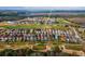 Wide aerial shot highlighting a neighborhood's beautiful homes, lush golf course, and serene community ambiance at 1041 Castle Pines Ct, Reunion, FL 34747