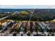 Aerial view showcasing homes with well-maintained lawns and a neighboring golf course, with lush greenery at 1041 Castle Pines Ct, Reunion, FL 34747