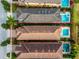 Aerial view of a home showcasing its roof and pool, nestled in a residential neighborhood with lush greenery at 1041 Castle Pines Ct, Reunion, FL 34747