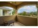 Balcony view, featuring a small table, chairs, and relaxing views of the natural surroundings with lush greenery at 1041 Castle Pines Ct, Reunion, FL 34747