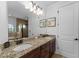Bathroom featuring double sinks, granite countertops, and access to the shower and tub at 1041 Castle Pines Ct, Reunion, FL 34747