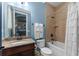 Updated bathroom with granite vanity, a bathtub and a shower with a tiled surround at 1041 Castle Pines Ct, Reunion, FL 34747